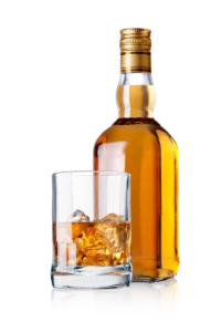 Bouteille de whisky accompagnée d’un verre sur glace, révélant ses arômes boisés et vanillés. ​​







